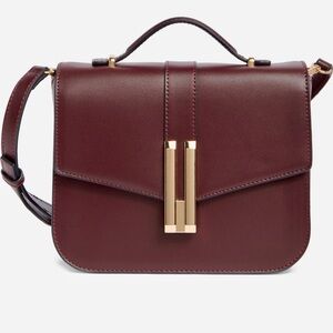 BCBG Burgundy Crossbody Bag with Gold Accents